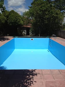 The final coat of blue paint is on the swimming pool