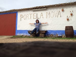 Laura sat on a bench below the Portela Nova sign