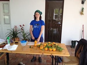 Laura cutting oranges in half for squeezing