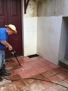 Dad pressure washing the outside tiles