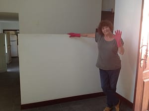 Mum standing next to the wall before we painted it red